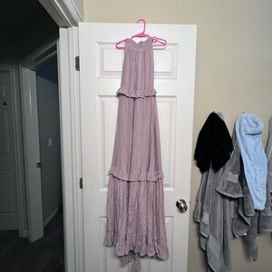 A high neck, tie in the back, no sleeves, maxi dress. *has an inner lining*